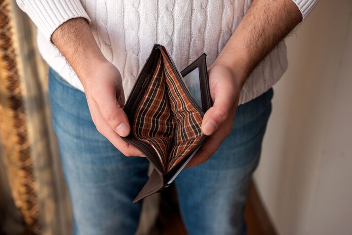 A person holding an empty wallet
AI-generated content may be incorrect.